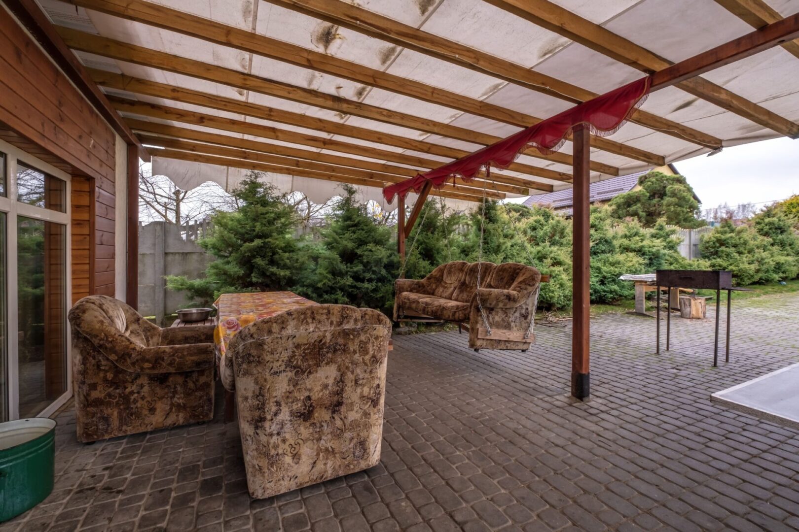 Covered patio with hanging sofa swing