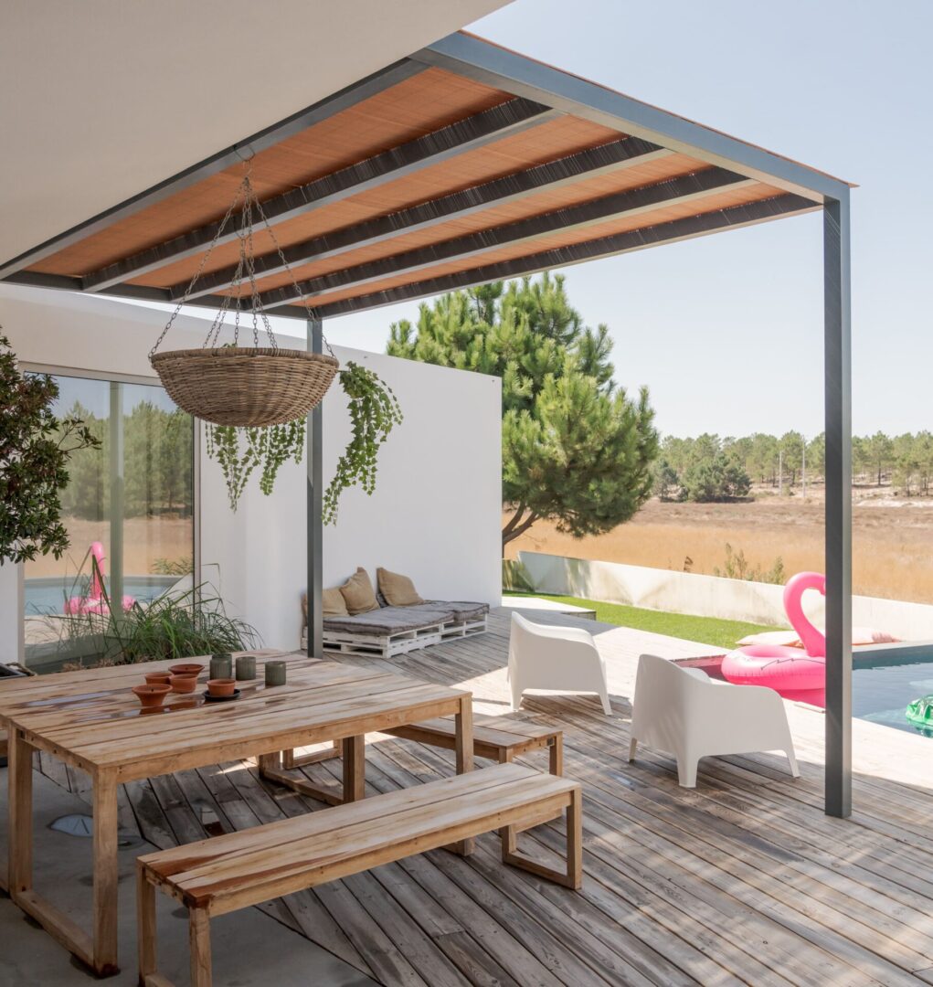 Covered patio with wooden table and flamingo float