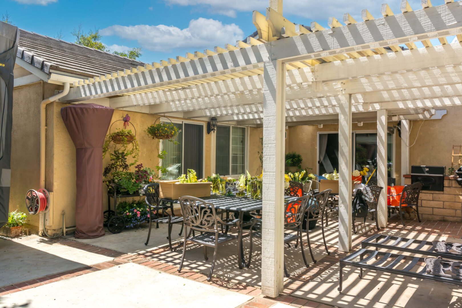 Sunlit pergola-covered patio with dining set