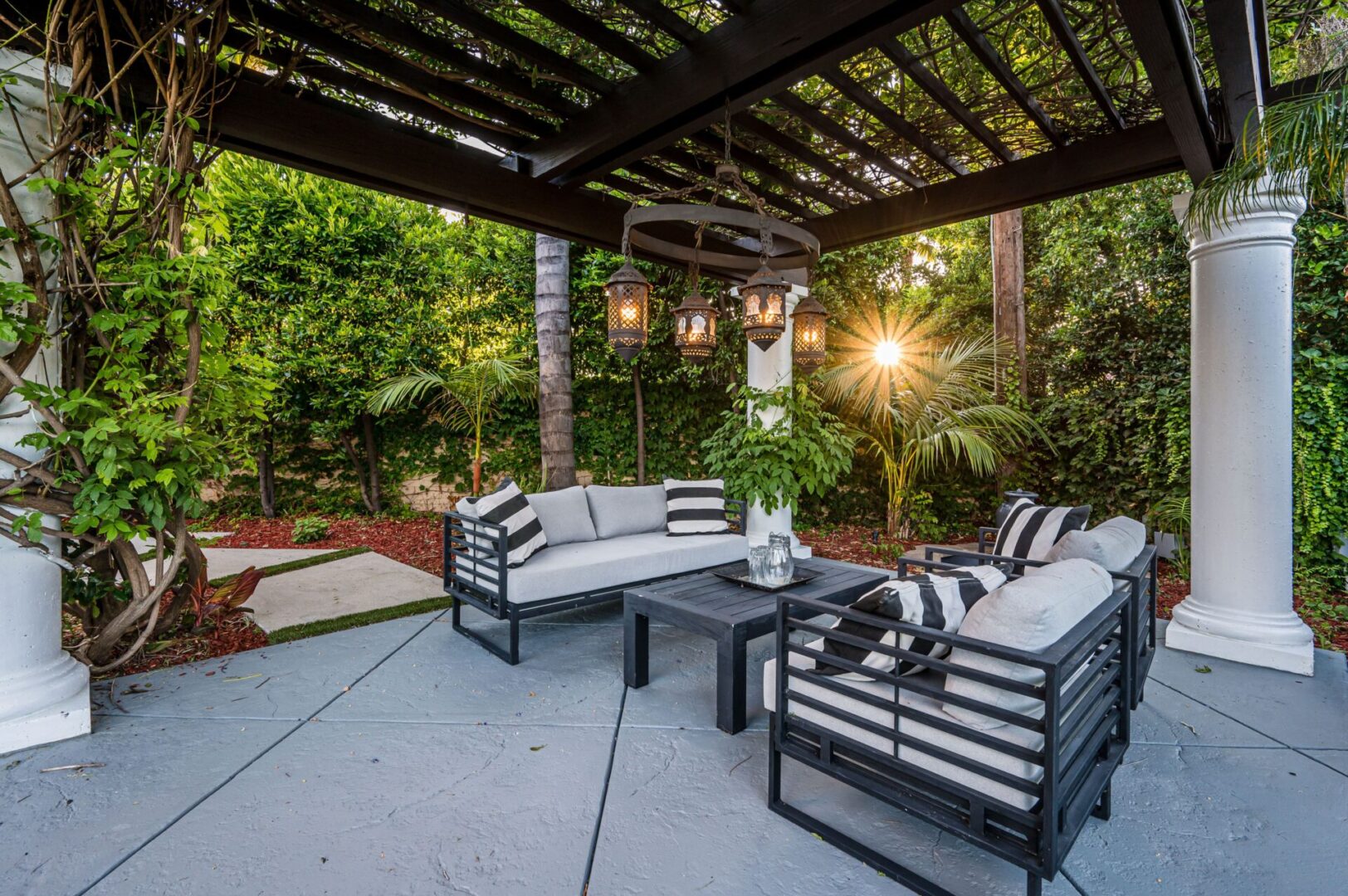 Outdoor patio seating under pergola with lanterns