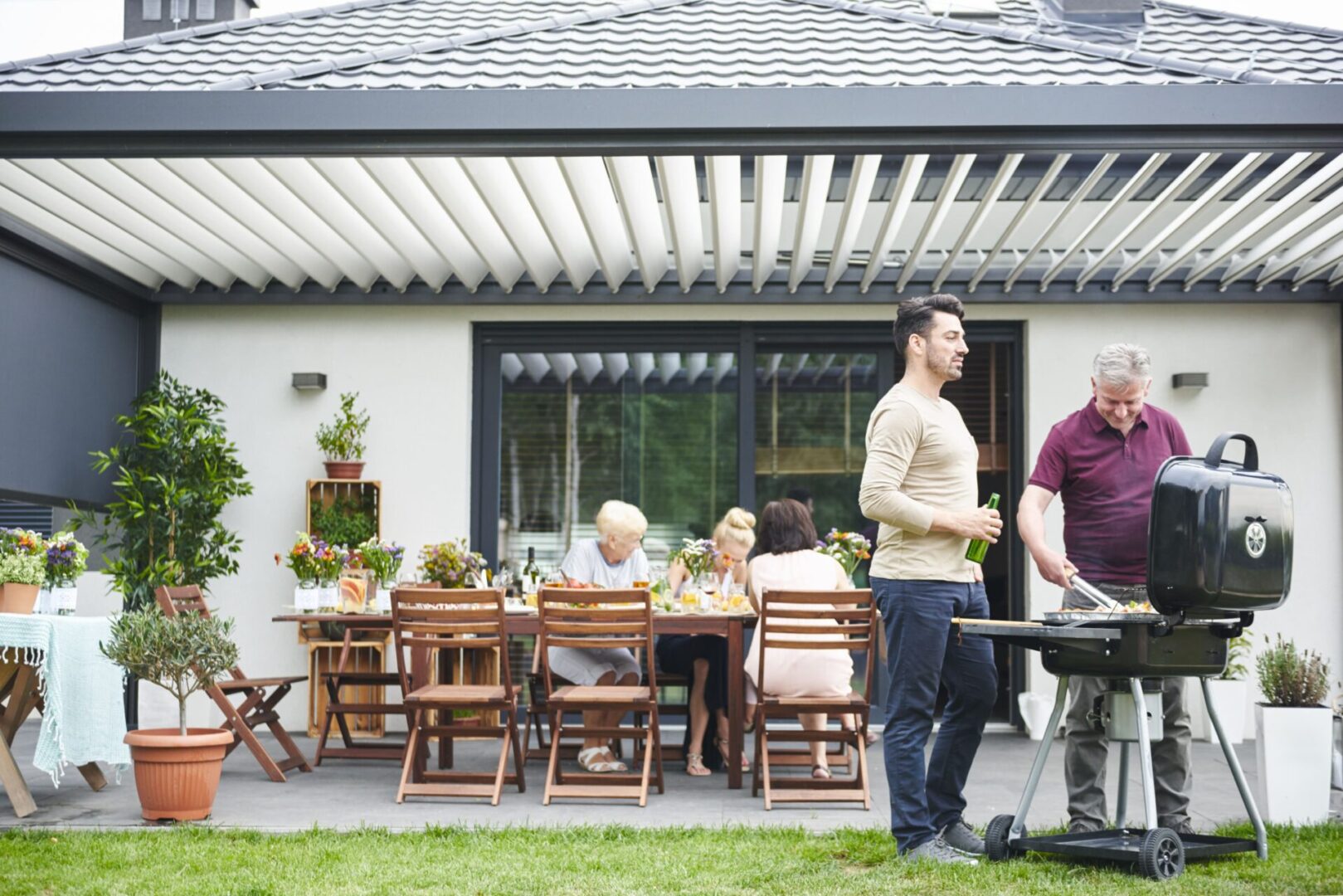 People grilling and dining on patio