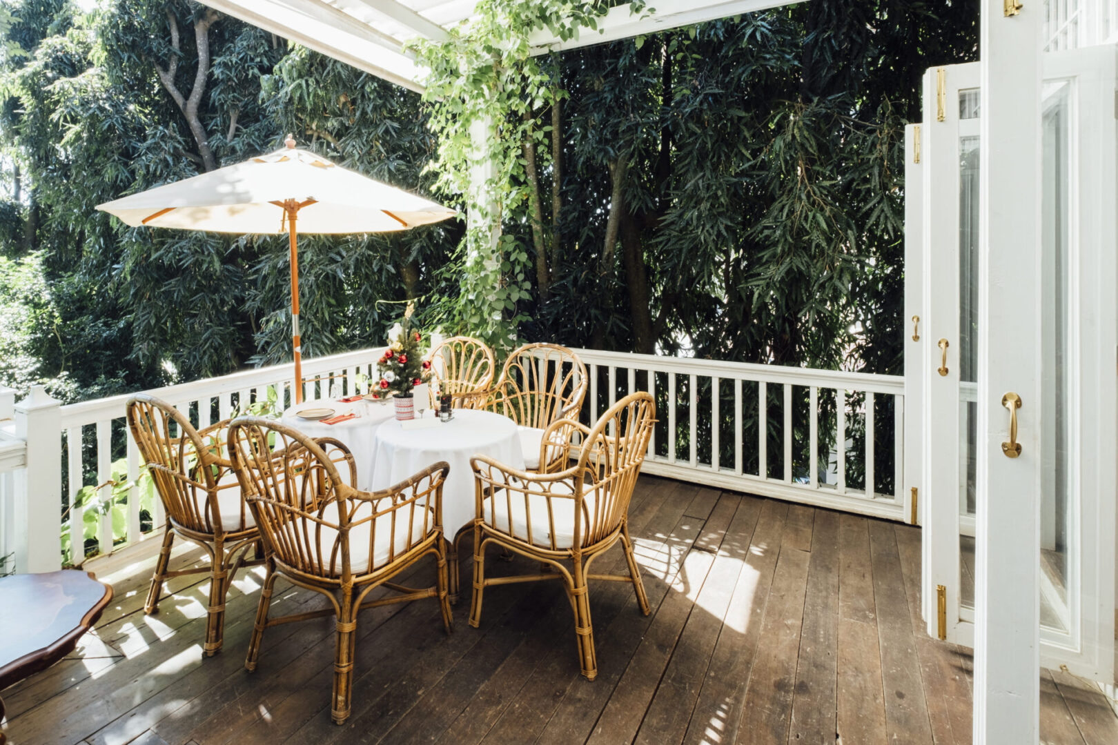 Sunny patio with wicker chairs and umbrella