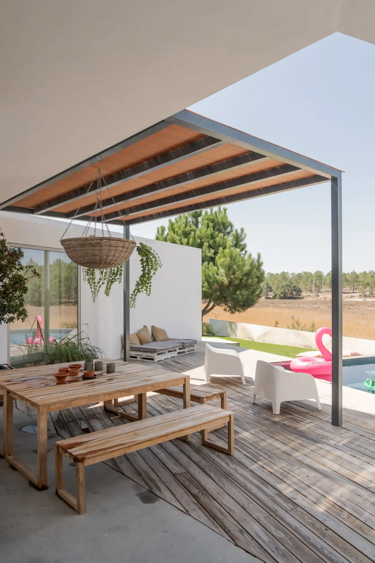 Covered patio with wooden table and pool