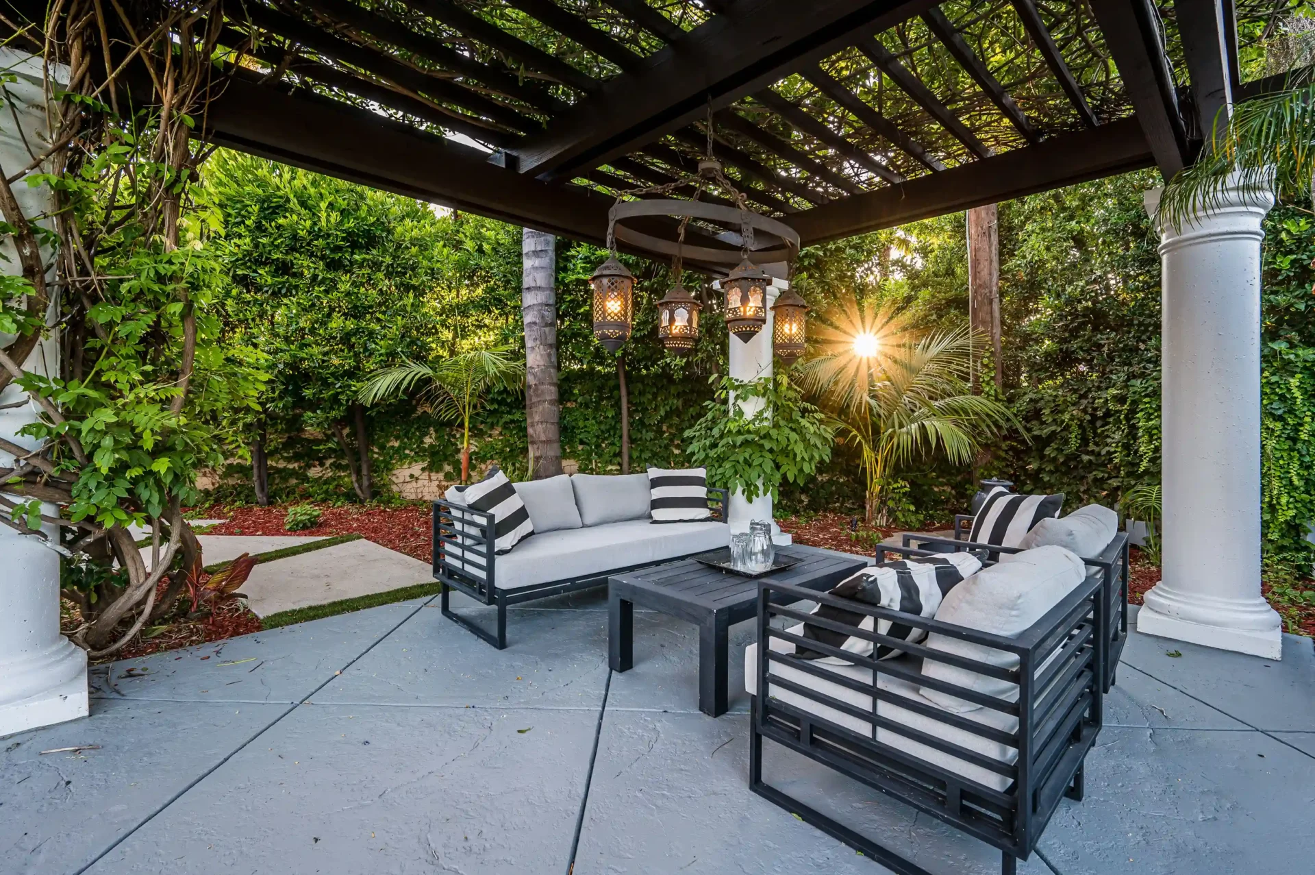 Gray sectional under vine-covered pergola
