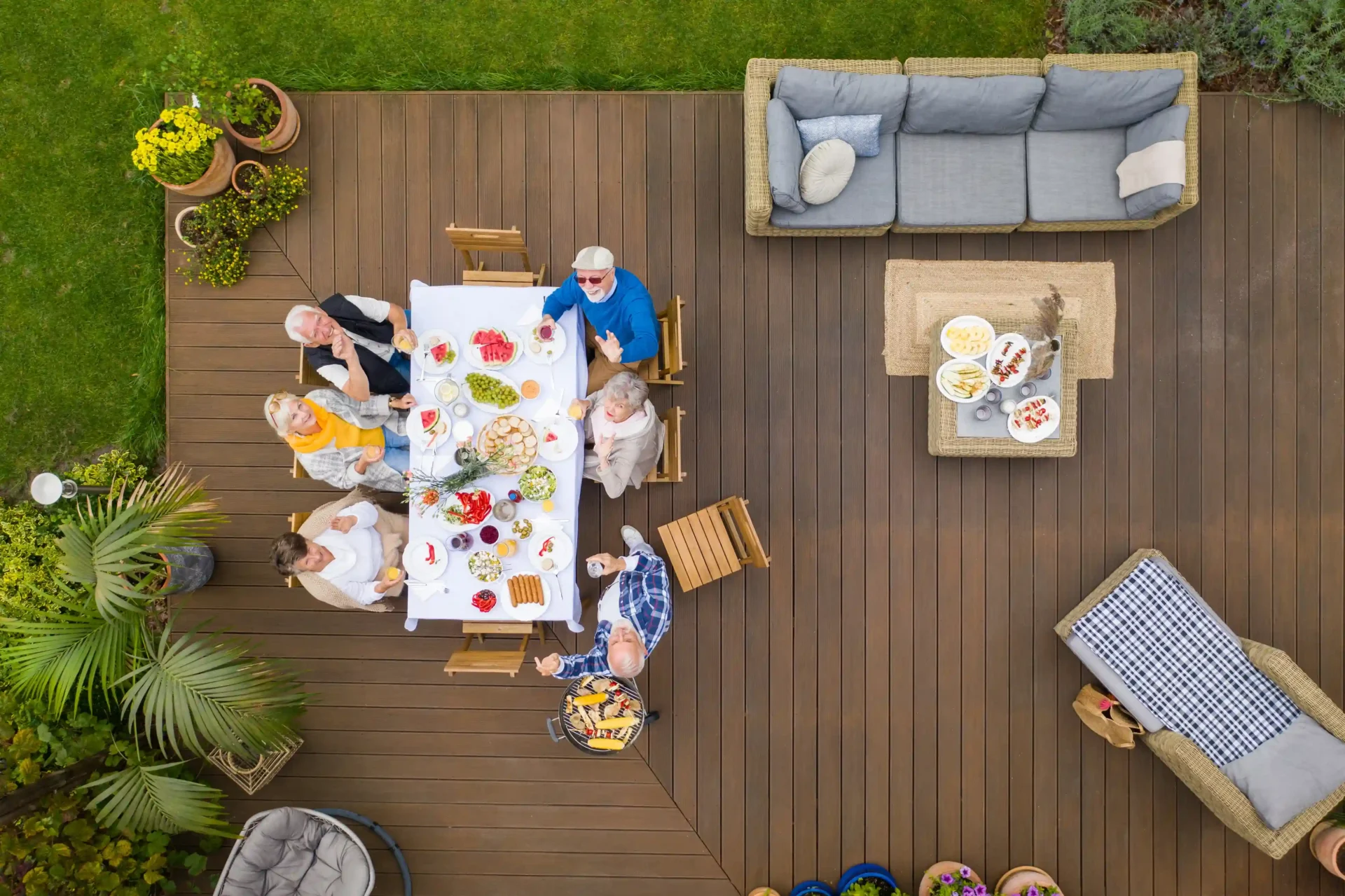 Aerial view of group dining on wooden deck