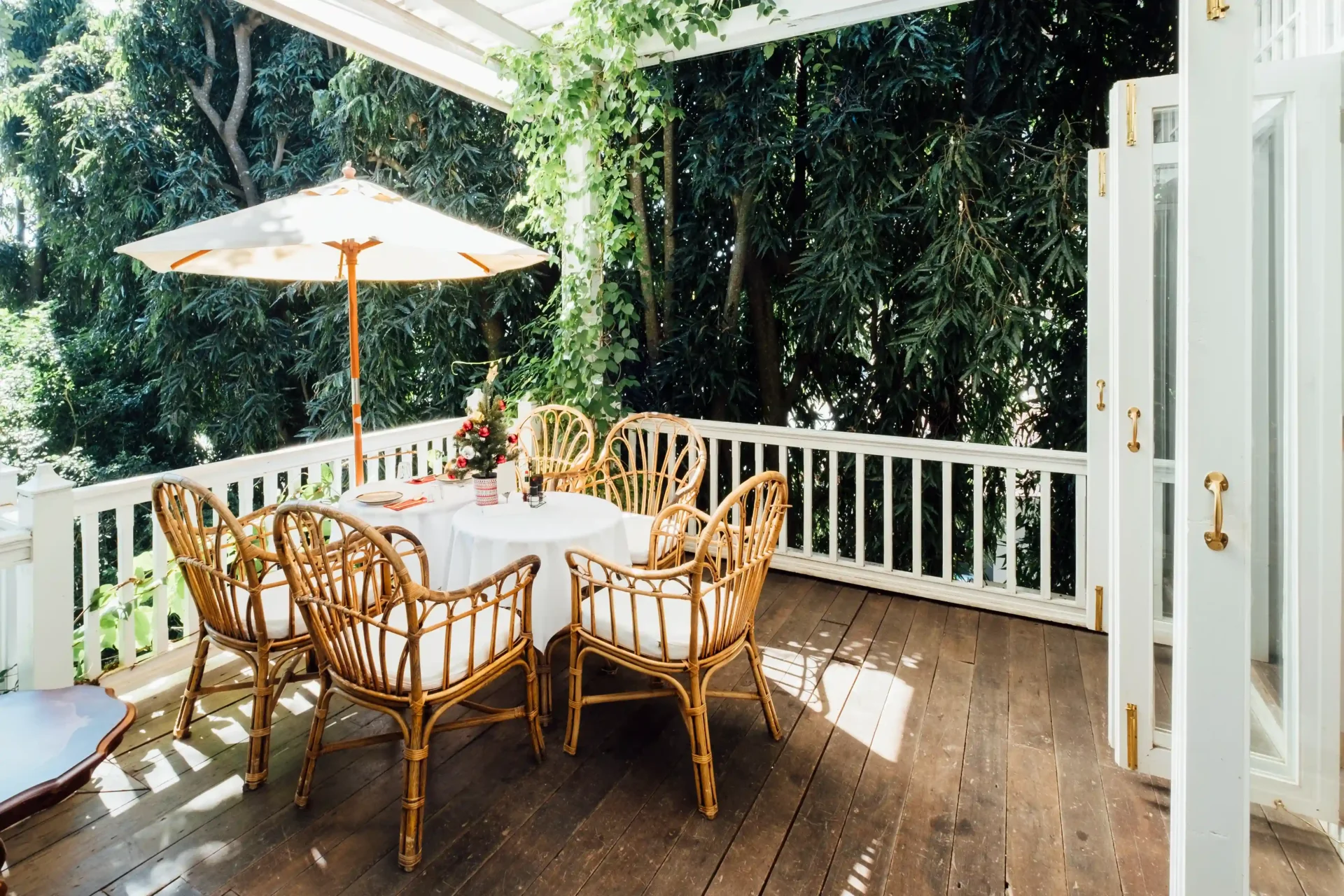 Sunlit porch dining table with wicker chairs