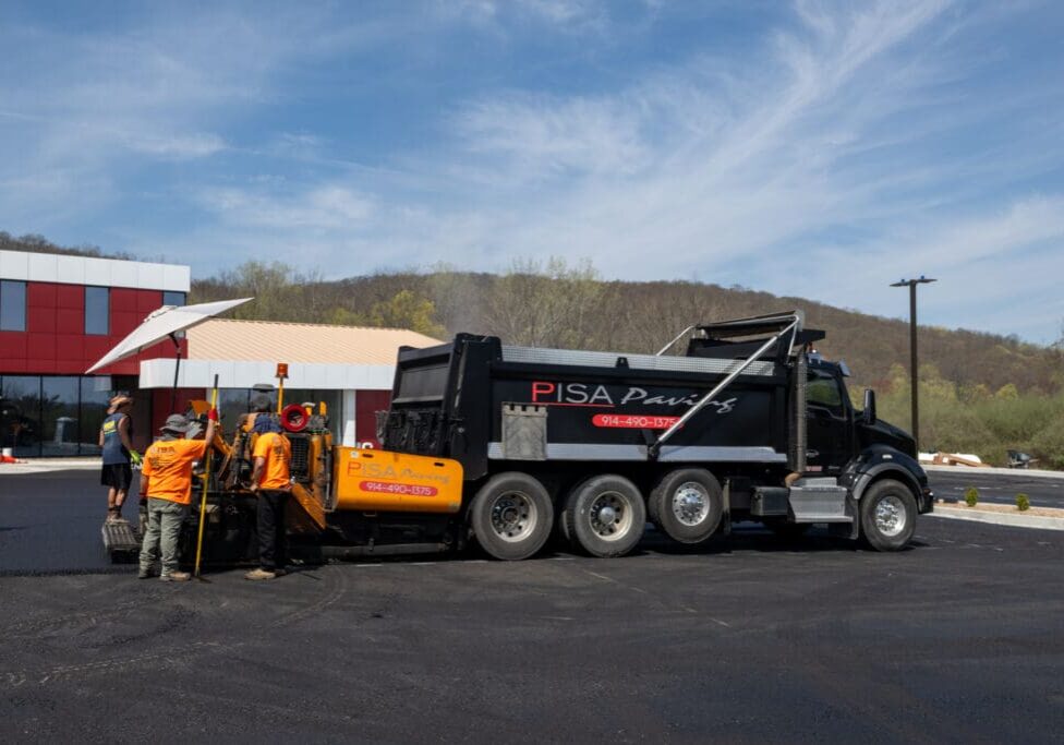 A dump truck parked in front of a building.