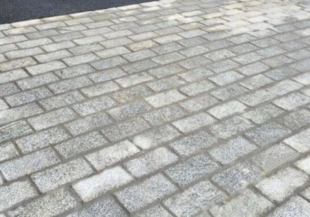 A close up of the driveway with brick pavers